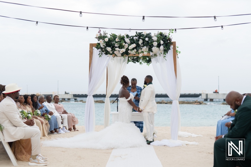 Celebrate love at a breathtaking wedding on the sandy shores of Mangrove Beach in Curacao with elegant decor and joyful guests enjoying the beautiful seaside setting
