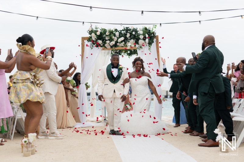 Celebration of love at Mangrove Beach Corendon in Curacao with a joyful wedding ceremony on the sandy shore during sunset