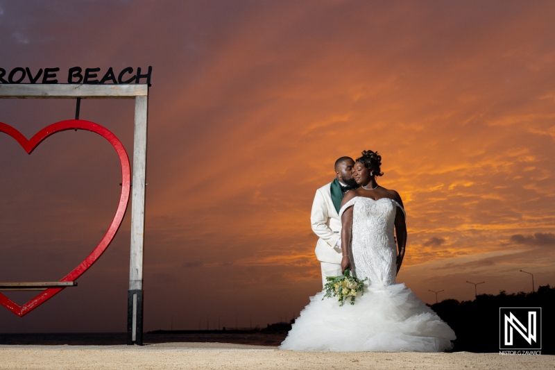 Couple celebrates love during sunset at Mangrove Beach Corendon in Curacao, creating memorable wedding moments by the shore
