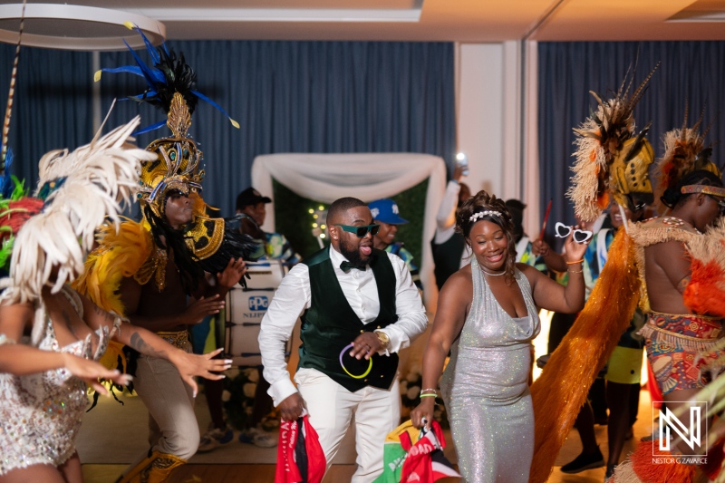 Celebration of love at Mangrove Beach Corendon in Curacao, couples and guests enjoy a vibrant wedding reception and unique cultural dance