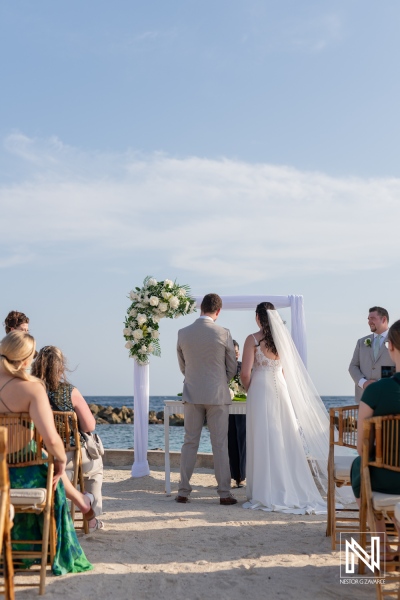 Beautiful wedding ceremony at Sunscape Curacao Resort with stunning ocean views and an elegant floral arch in the backdrop