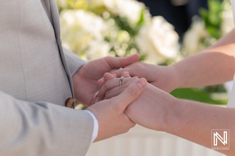 Couple exchanges vows in romantic ceremony at Sunscape Curacao Resort surrounded by lush scenery and intimate floral arrangements