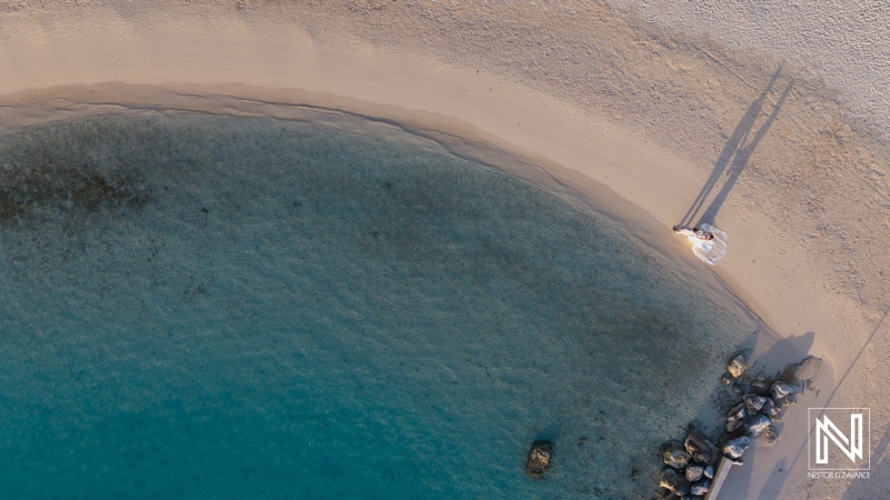 Stunning beach wedding at Sunscape Curacao Resort captures the essence of love as a couple enjoys their special day by the clear blue waters