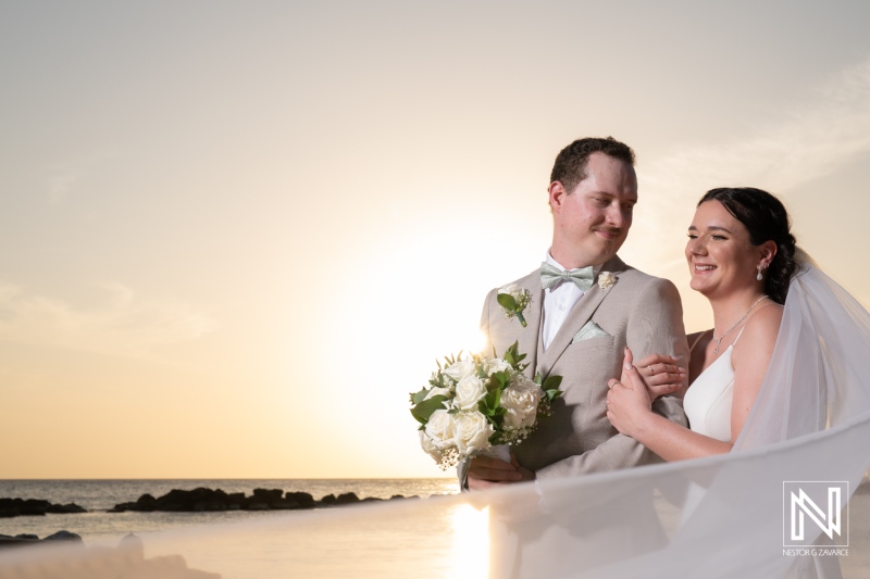 Couple celebrates their wedding at Sunscape Curacao Resort during a stunning sunset on the beach