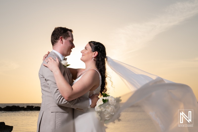 Beautiful wedding couple celebrating their love at Sunscape Curacao Resort during a stunning sunset