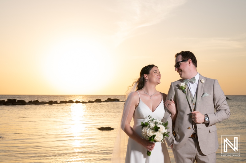Couple shares joyful moment on their wedding day at Sunscape Curacao Resort during a picturesque sunset by the ocean