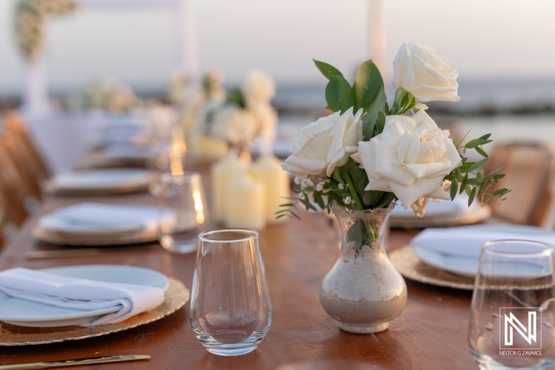 Elegant wedding setup at Sunscape Curacao Resort with beautiful floral arrangements and sunset backdrop