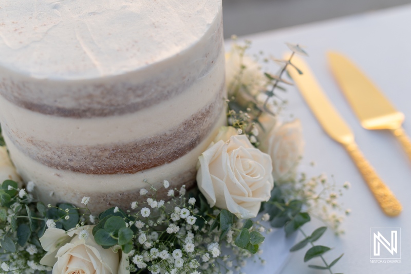 Beautiful wedding cake adorned with fresh flowers at Sunscape Curacao Resort during a romantic ceremony in paradise