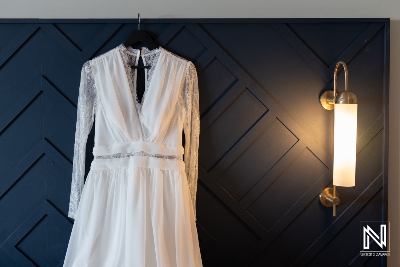 Elegant wedding dress hanging in a venue at Mangrove Beach Corendon in Curacao, ready for a beautiful beach ceremony