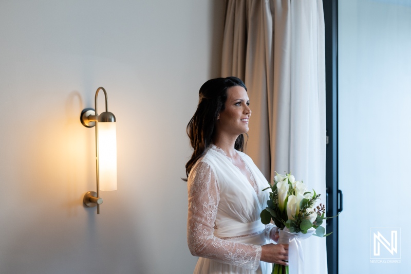 Beautiful bride preparing for wedding ceremony at Mangrove Beach in Curacao with stunning floral bouquet in hand