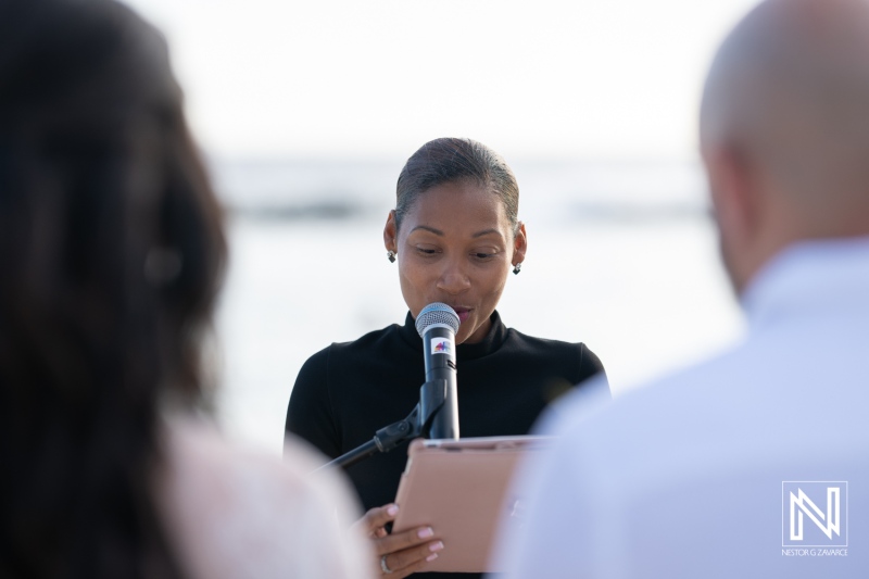 Ceremony taking place on the beach in Curacao at Mangrove Beach Corendon with officiant addressing the couple