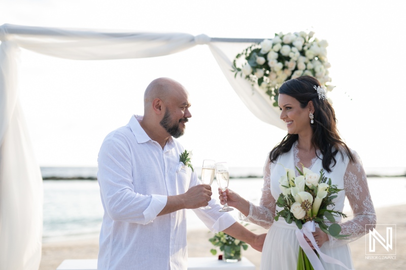 Couple celebrating their wedding with champagne toast at Mangrove Beach in Curacao during sunset