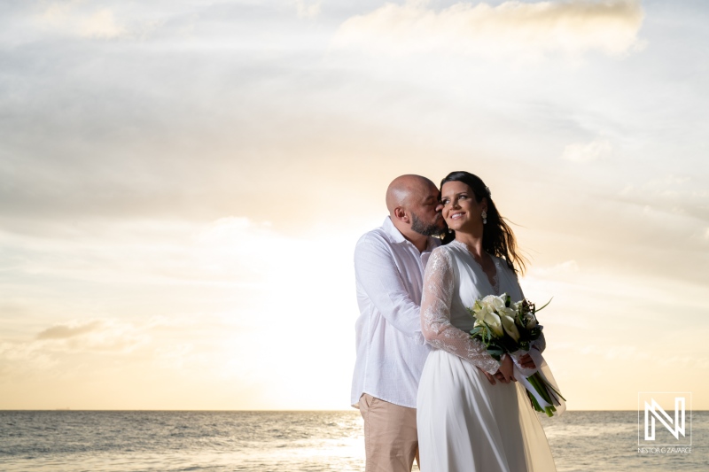 Couple celebrates their wedding on the beautiful shores of Mangrove Beach in Curacao during a picturesque sunset