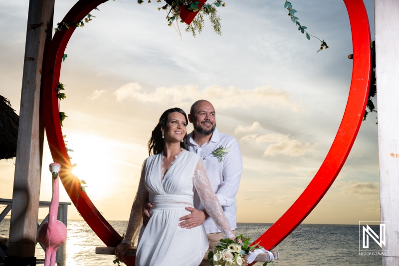 Couple celebrates their wedding at sunset on Mangrove Beach in Curacao surrounded by love and tropical beauty