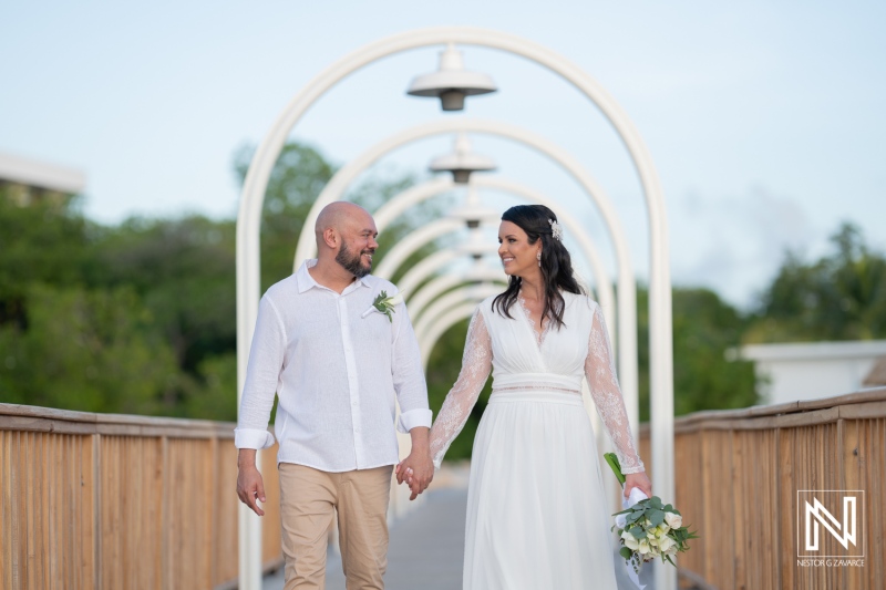 Couple enjoys a romantic walk while celebrating their wedding at Mangrove Beach in Curacao during a beautiful sunny day