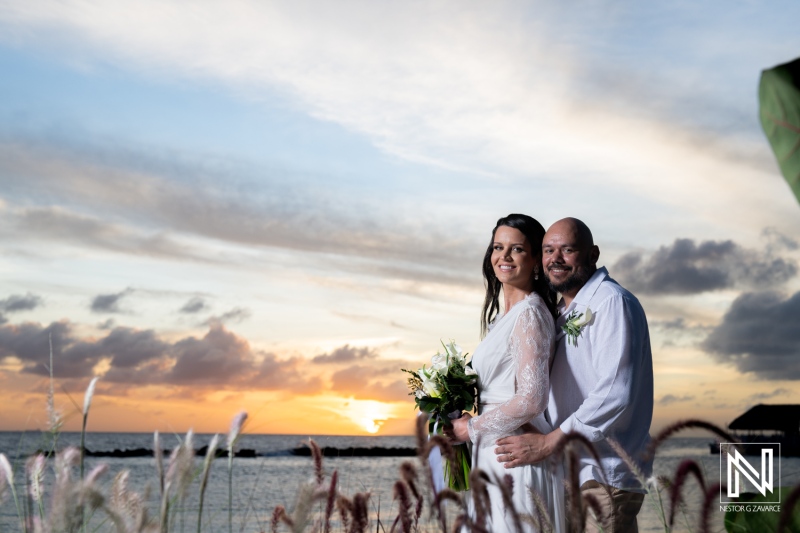 Couple embraces during sunset wedding at Mangrove Beach in Curacao, showcasing love and joy in a beautiful tropical setting