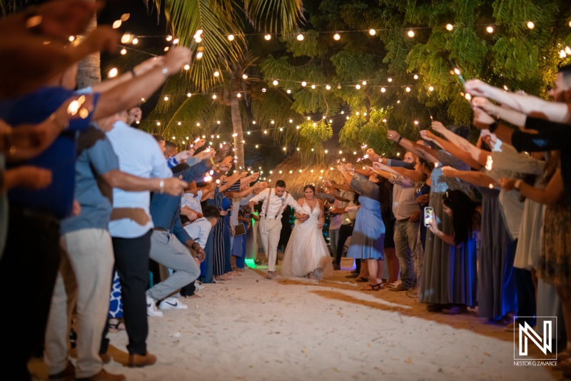 Bride and groom walking between sparkles