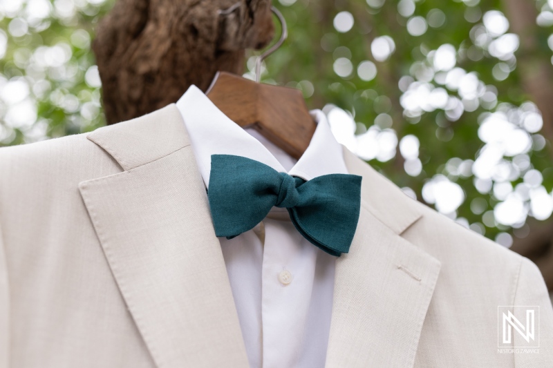 Elegant bow tie hanging on a suit at a wedding in Curacao on a bright day in nature