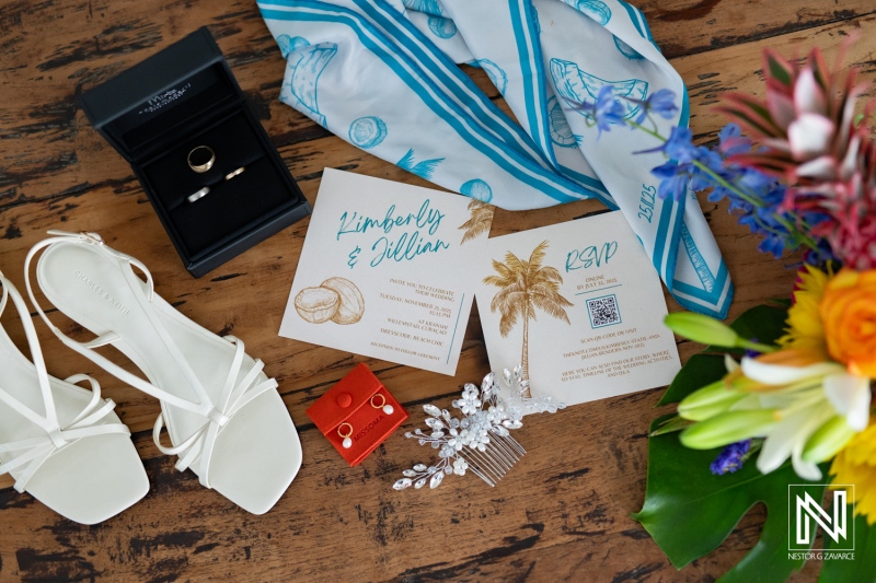 Wedding details are arranged on a table at a venue in Curacao for Kimberly and Jillian's celebration