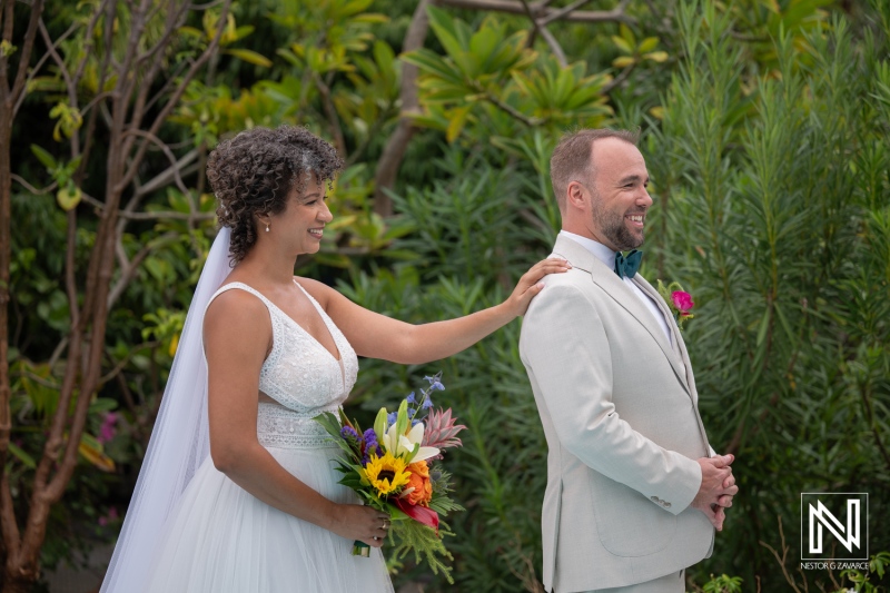 Couple celebrates wedding ceremony in Curacao with joyful smiles and bright flowers
