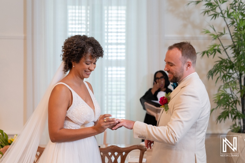 Couple exchanges rings during wedding ceremony in Curacao with guests present