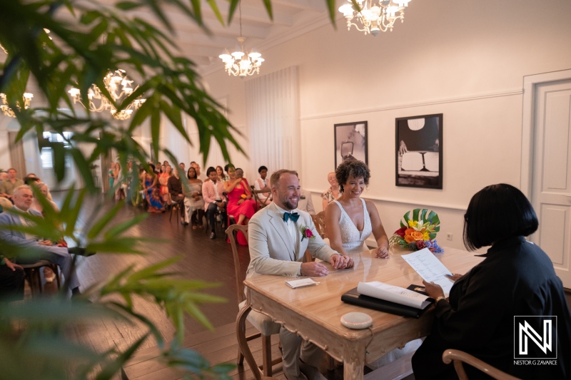 Wedding ceremony in Curacao with guests seated and officiant at table during a special moment in the daytime