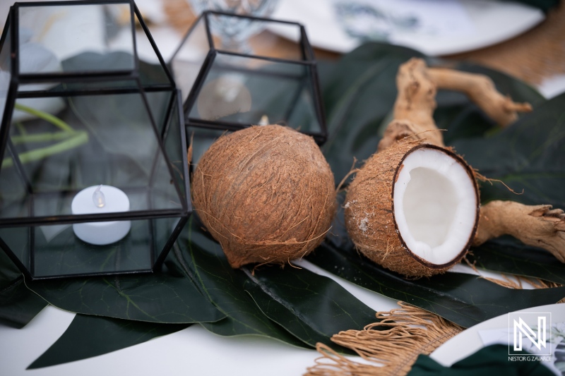 Wedding decor with coconuts at a celebration in Curacao near tropical plants and lanterns