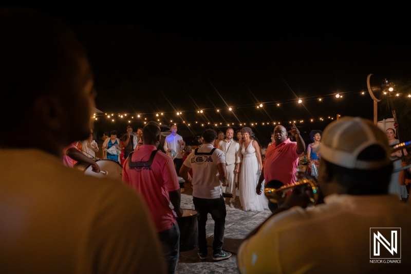 Wedding celebration in Curacao features a lively band and guests enjoying the night under string lights