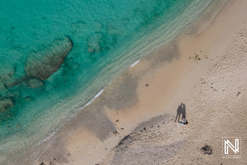 Aerial Shot of Bride and groom at turquoise beach in Curacao