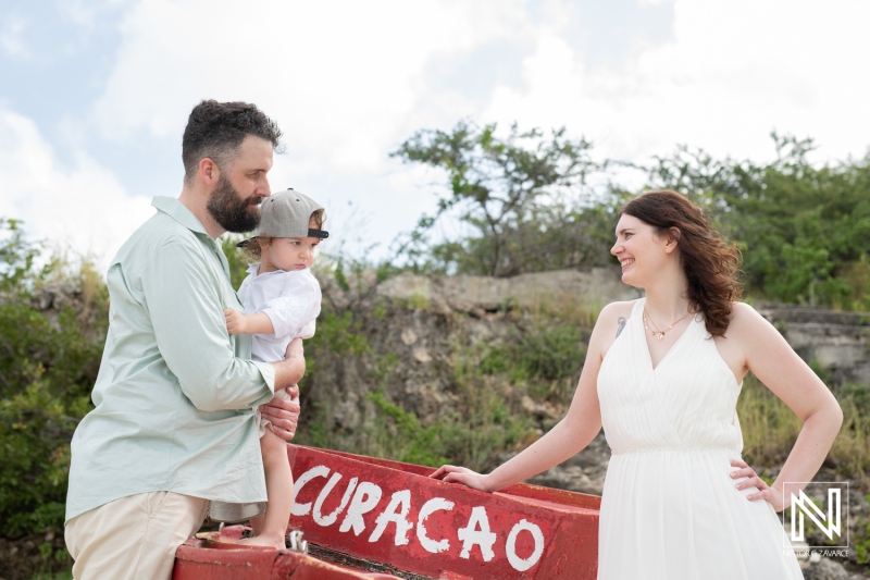 Bride and groom with kid photoshoot at fisherman boat in Curacao