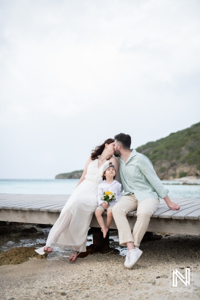 Bride and groom kissing at beach pier in Curacao