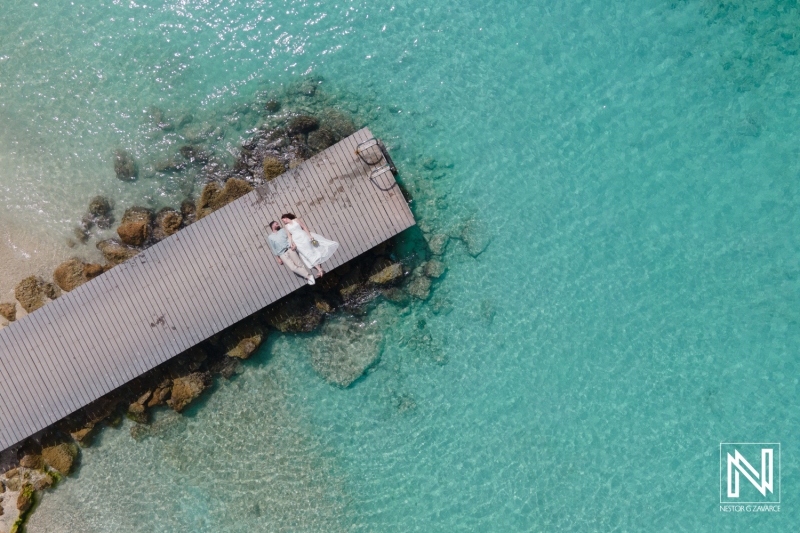 Aerial Shot of Bride and groom at pier of turquoise beach in Curacao