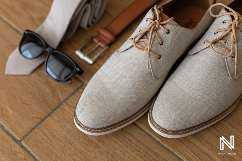 Elegant wedding attire preparation at Sunscape Curacao Resort with light-colored shoes, sunglasses, and accessories