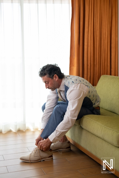 Groom preparing for wedding at Sunscape Curacao Resort, capturing moments of excitement and anticipation in beautiful surroundings