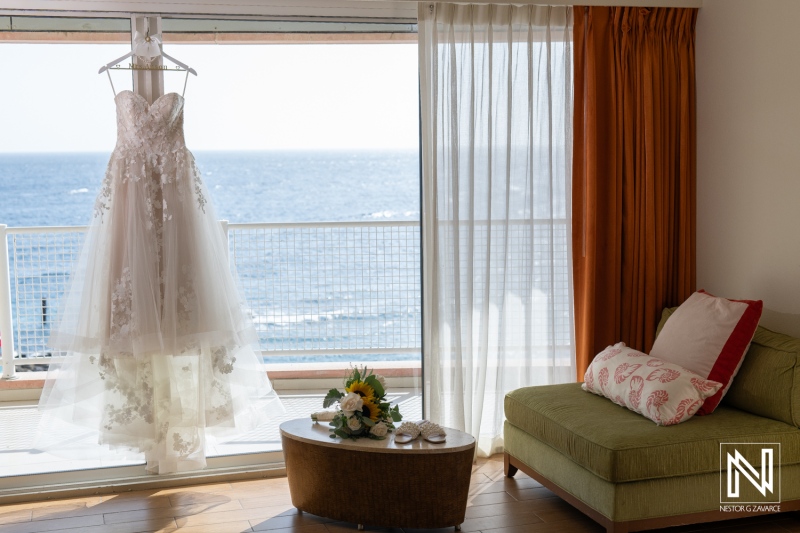 Beautiful wedding dress displayed in a coastal room at Sunscape Curacao Resort with ocean views for a wedding ceremony preparation