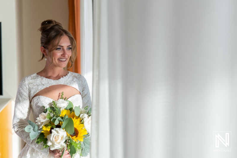 Bride prepares for a beautiful wedding at Sunscape Curacao Resort with bright flowers and natural light