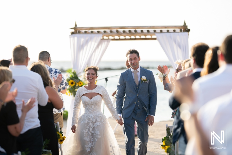 Beautiful couple exits ceremony as newlyweds at Sunscape Curacao Resort during a sunset wedding celebration