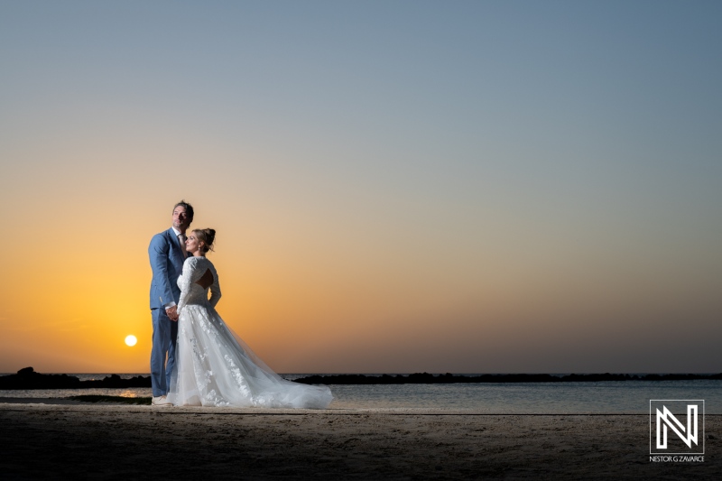 Couple celebrates their wedding during a stunning sunset at Sunscape Curacao Resort in Curacao