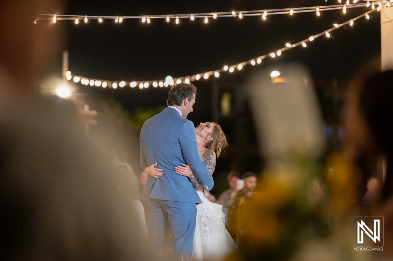 Wedding couple shares an intimate moment under twinkling lights at Sunscape Curacao Resort in a romantic evening setting