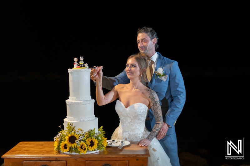 Wedding celebration at Sunscape Curacao Resort with a beautiful cake and joyful couple enjoying their special moment together