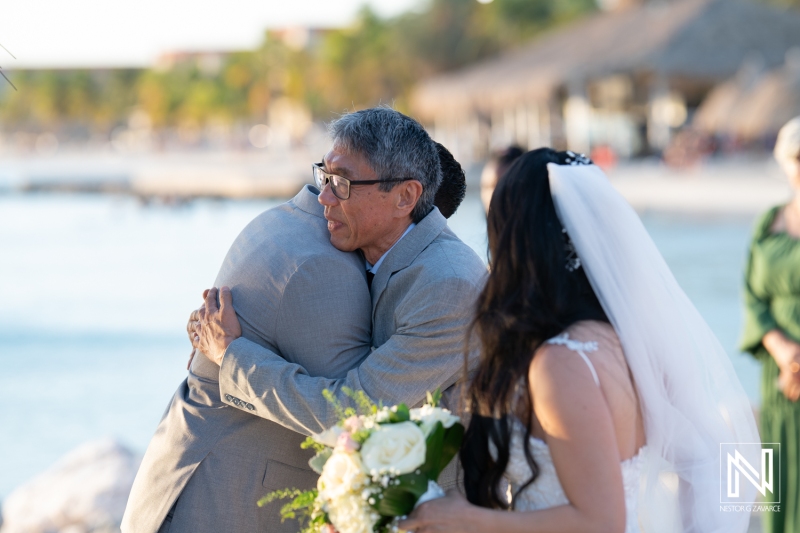 Groom and father of the bride hug