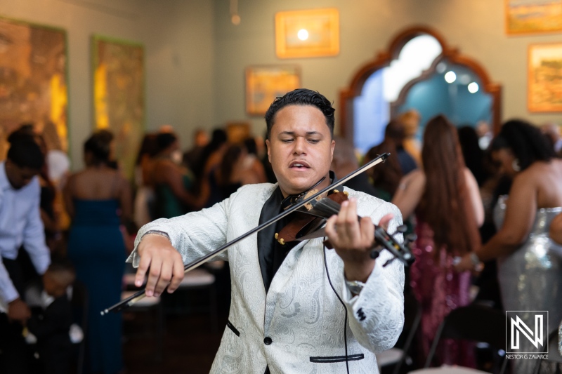 Celebration in Curacao with a violinist performing at a vibrant wedding reception at the Curaçao Museum