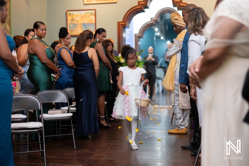 Wedding ceremony at the Curaçao Museum with flower girl walking down the aisle in Curacao