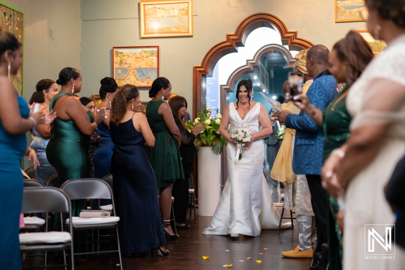 Ceremony celebrating love unfolds at the Curaçao Museum with vibrant guests and a beautiful bride