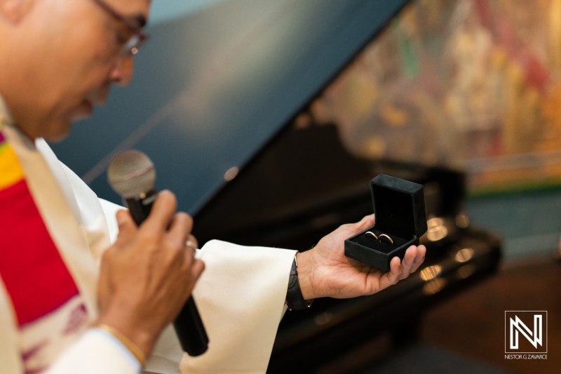 Ceremony at the Curaçao Museum featuring the exchange of wedding rings in a beautiful setting