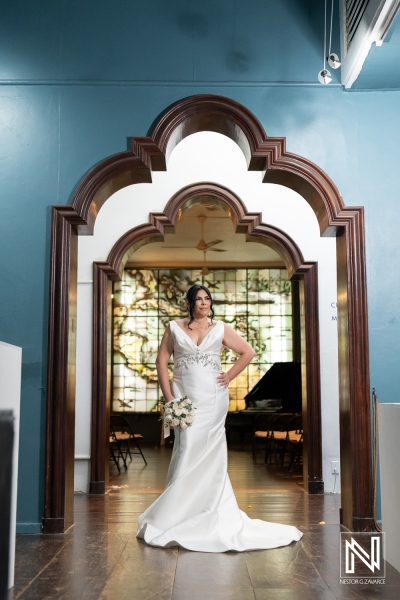 Beautiful bride poses elegantly in the Curaçao Museum before her wedding ceremony