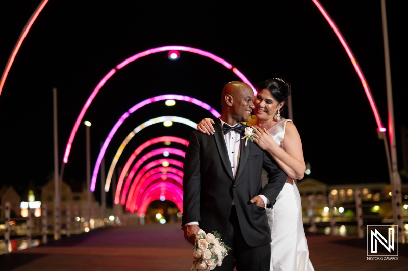 Couple celebrates wedding night at the Curaçao Museum under vibrant archway lights