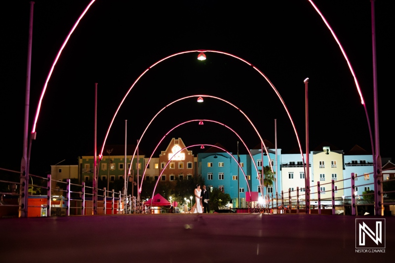 Couple celebrates their wedding under colorful lights at the Curaçao Museum in Curacao during a romantic night setting