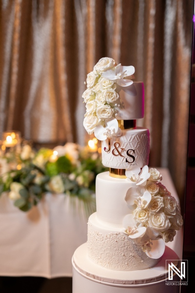 Elegant wedding cake with floral embellishments at a romantic wedding in Curacao's Curaçao Museum