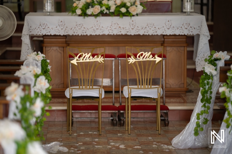 Wedding setup in Curacao with chair decorations for Mr and Mrs at the altar with floral arrangements